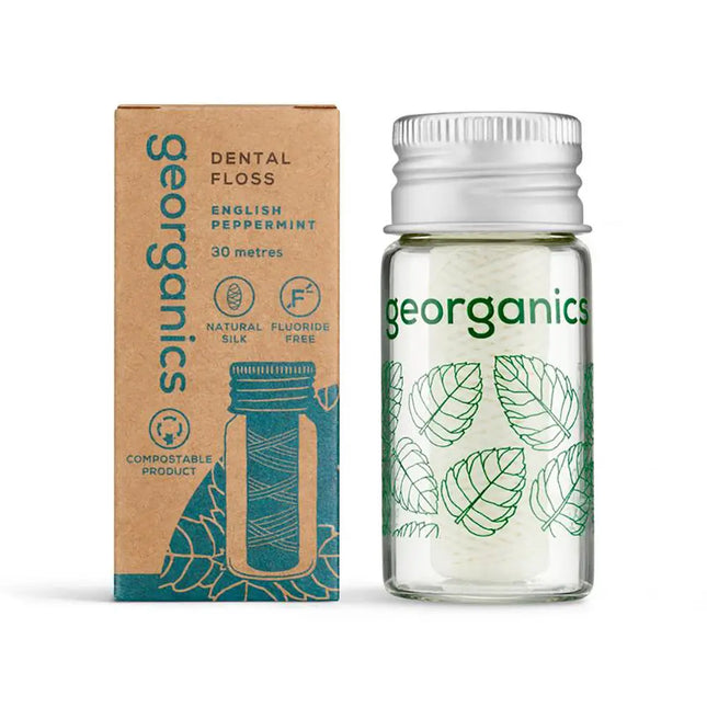 Georganics tandzijde met Engelse pepermunt in glazen dispenser naast composteerbare verpakking